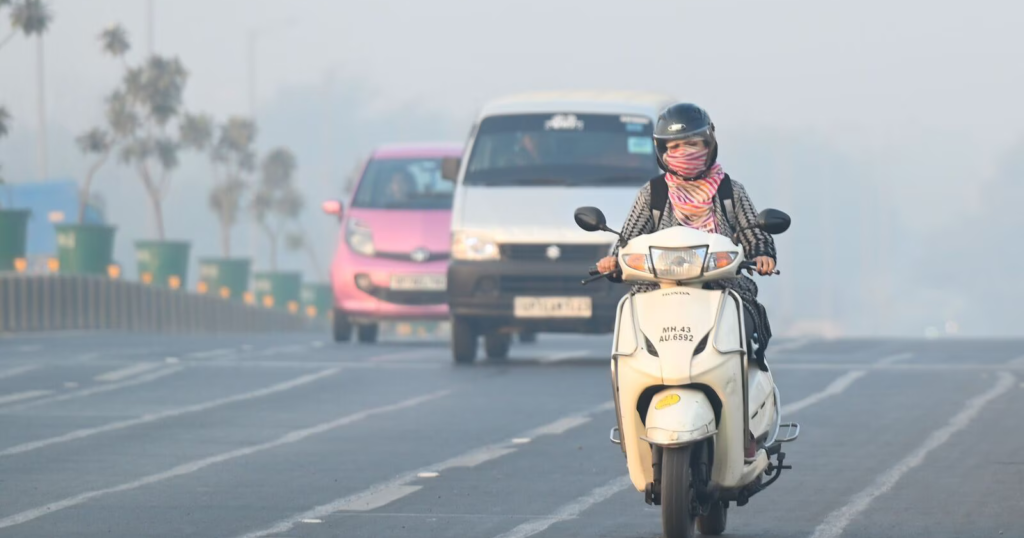 An electric scooter being charged at a public EV station in Delhi