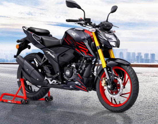 2025 TVS Apache RTR 200 4V in Matte Black with red alloy wheels on a city street