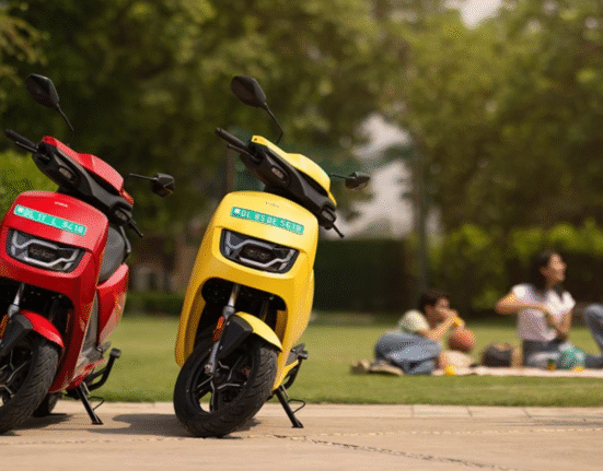 Hero Vida VX2 electric scooter parked on side stand in red and yellow color options