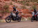two riders are doing off road activity both are riding triumph scrambler 1200 x