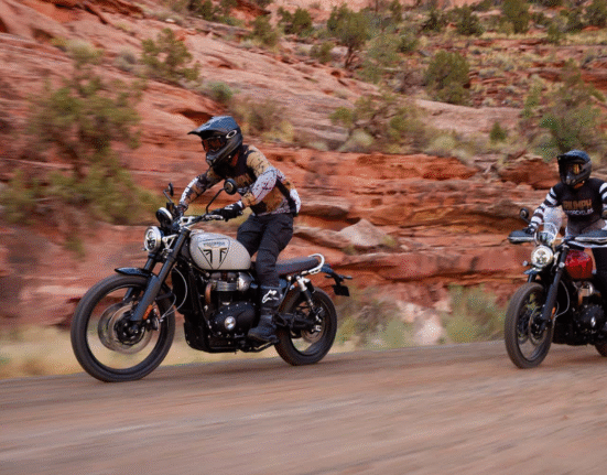 two riders are doing off road activity both are riding triumph scrambler 1200 x
