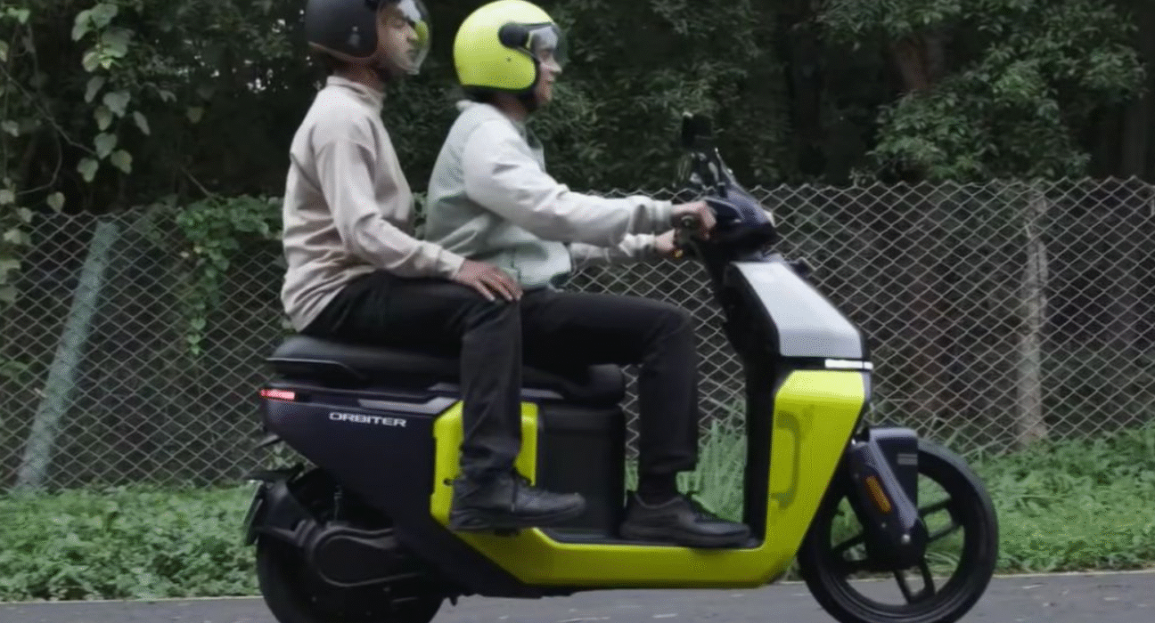 Riders riding TVS Orbiter electric scooter with pillion