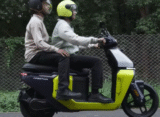 Riders riding TVS Orbiter electric scooter with pillion