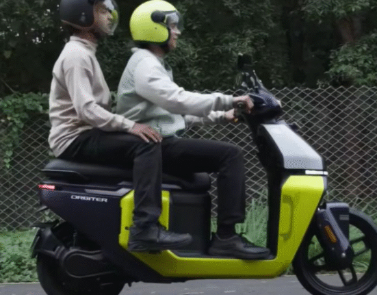 Riders riding TVS Orbiter electric scooter with pillion