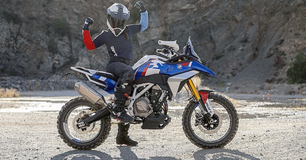 Rider posing with the new BMW F450 GS showcasing the bike’s powerful stance and rugged design