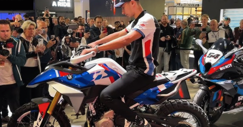 Motorcycle enthusiast checking BMW F450 GS seat height at the showcase event auditorium