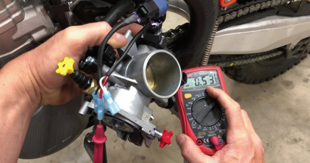 Technician checking throttle position sensor function on motorcycle