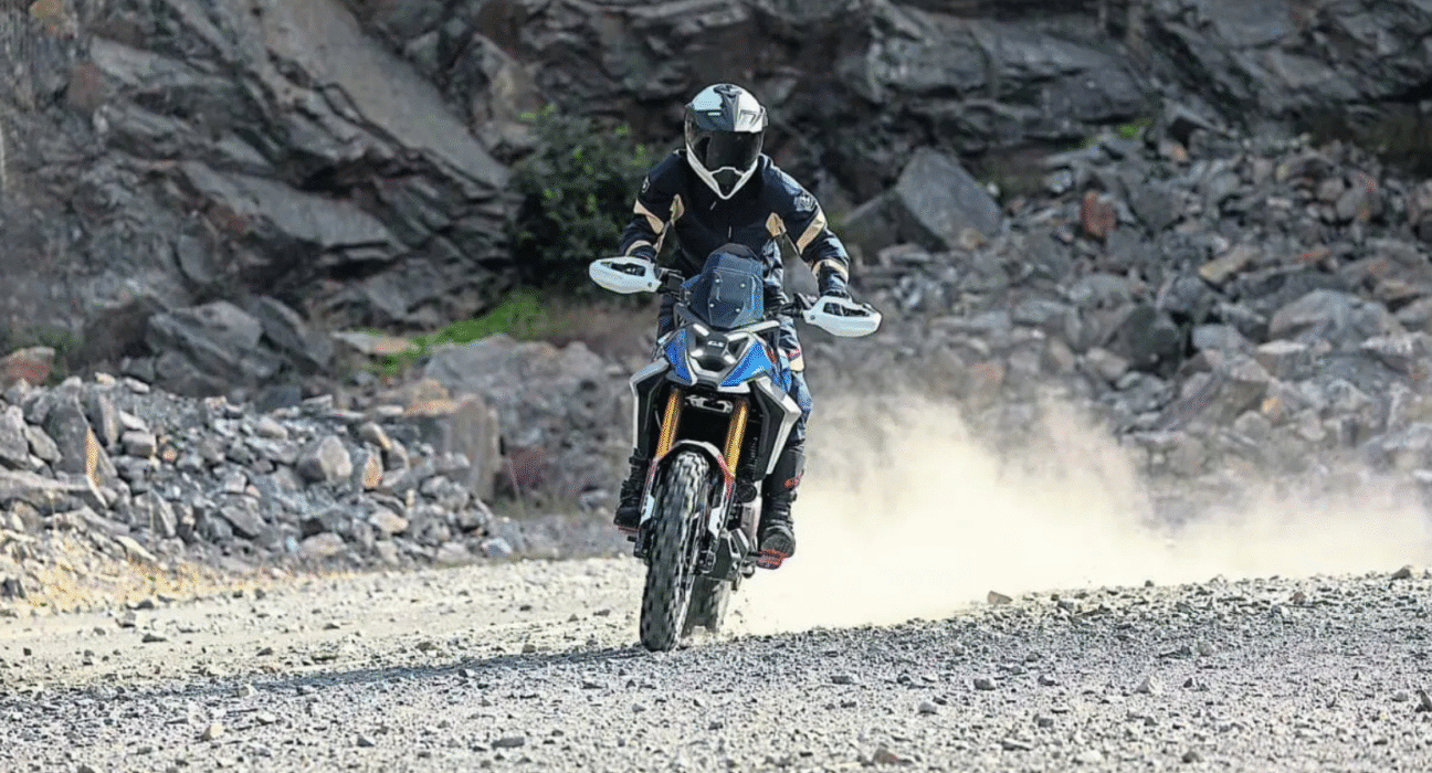 BMW F 450 GS adventure bike riding off-road, demonstrating suspension travel and rugged design