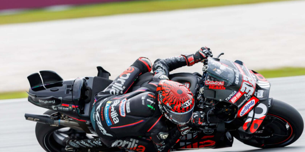 Aprilia RS-GP26 MotoGP bike in action during a track session, highlighting aggressive lean angle and race aerodynamics