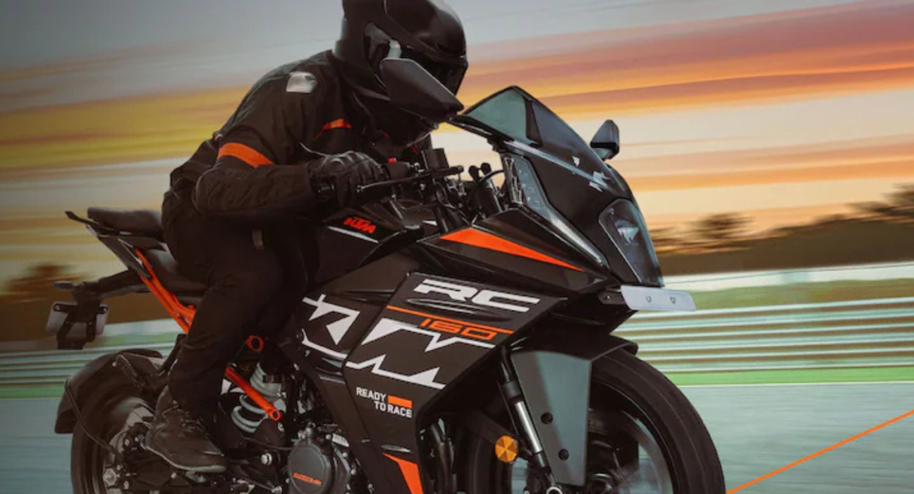 Rider riding the KTM RC 160 on the road with sunset in the background