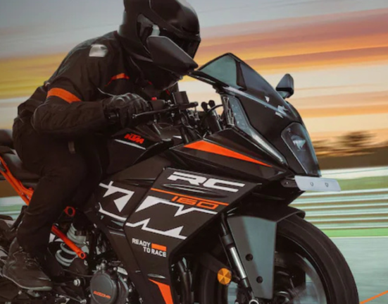 Rider riding the KTM RC 160 on the road with sunset in the background