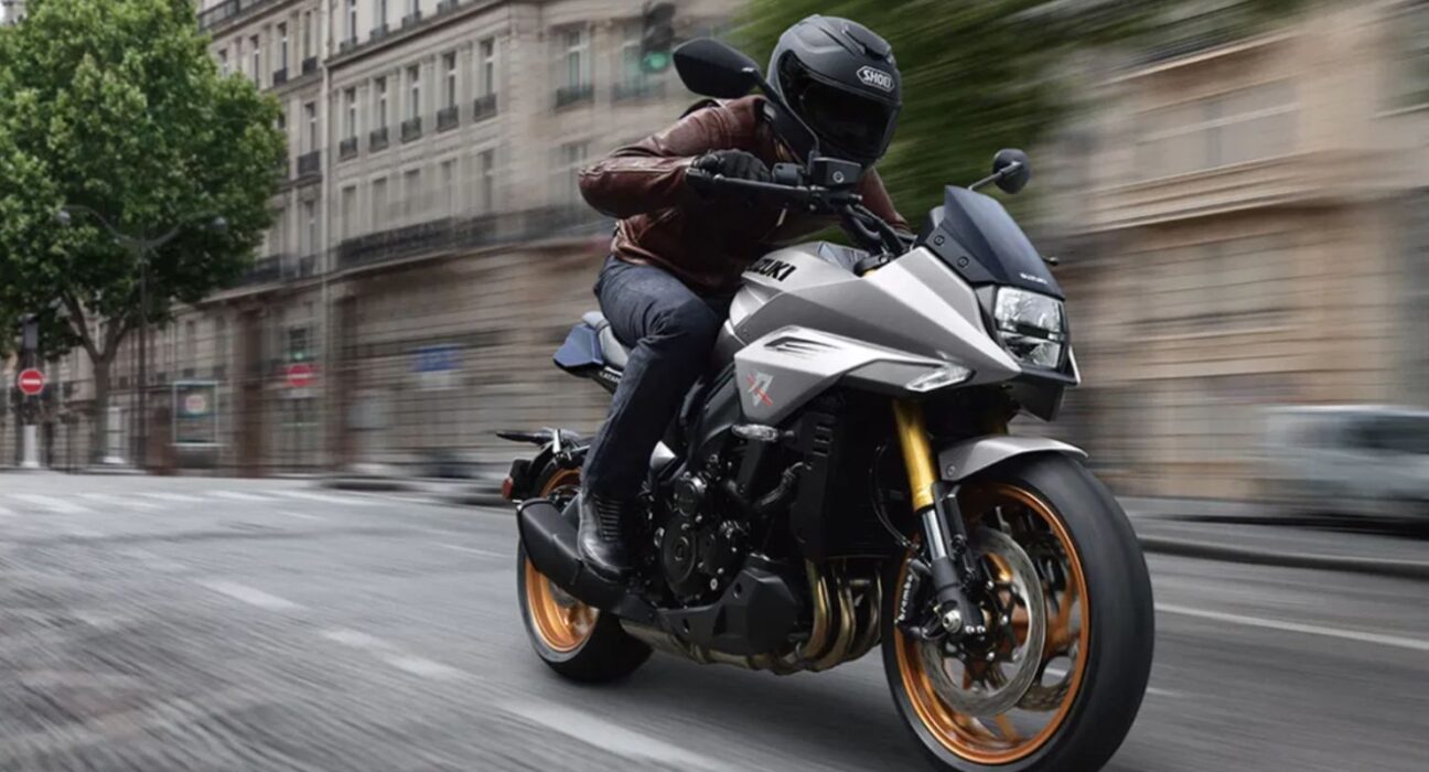Suzuki Katana Limited Edition motorcycle riding shot showing silver bodywork and bronze alloy wheels