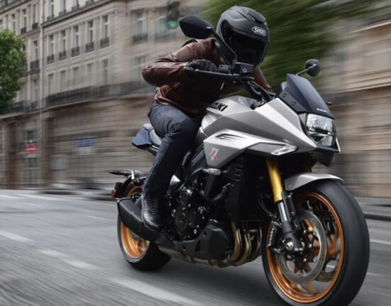 Suzuki Katana Limited Edition motorcycle riding shot showing silver bodywork and bronze alloy wheels
