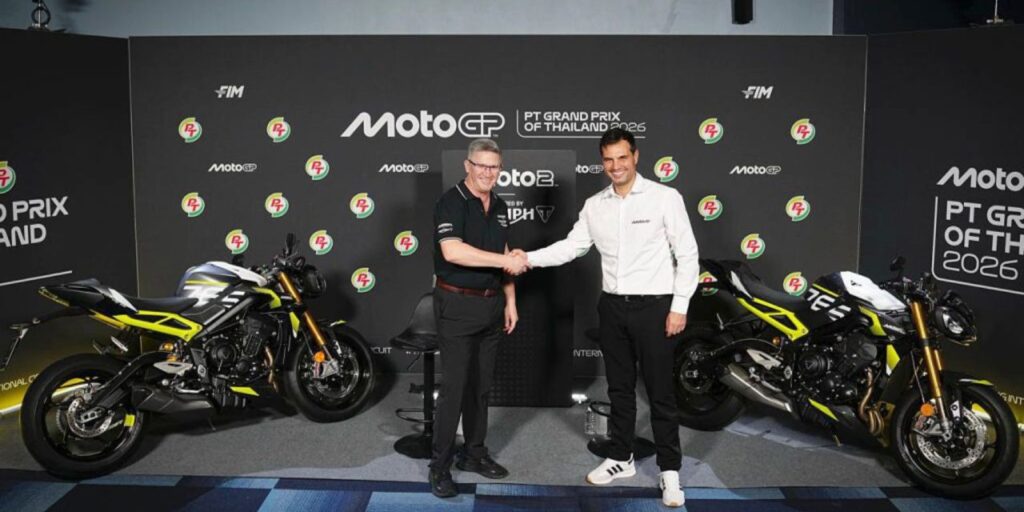 Executives reveal the Street Triple 765 Moto2 Edition motorcycles at a press event for the Moto2 World Championship Triple Trophy.